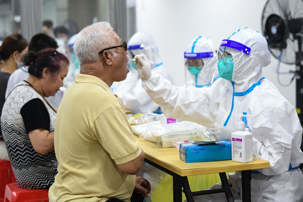 A medical worker collects swab samples in Guangzhou’s Liwan district. Photo: Xinhua