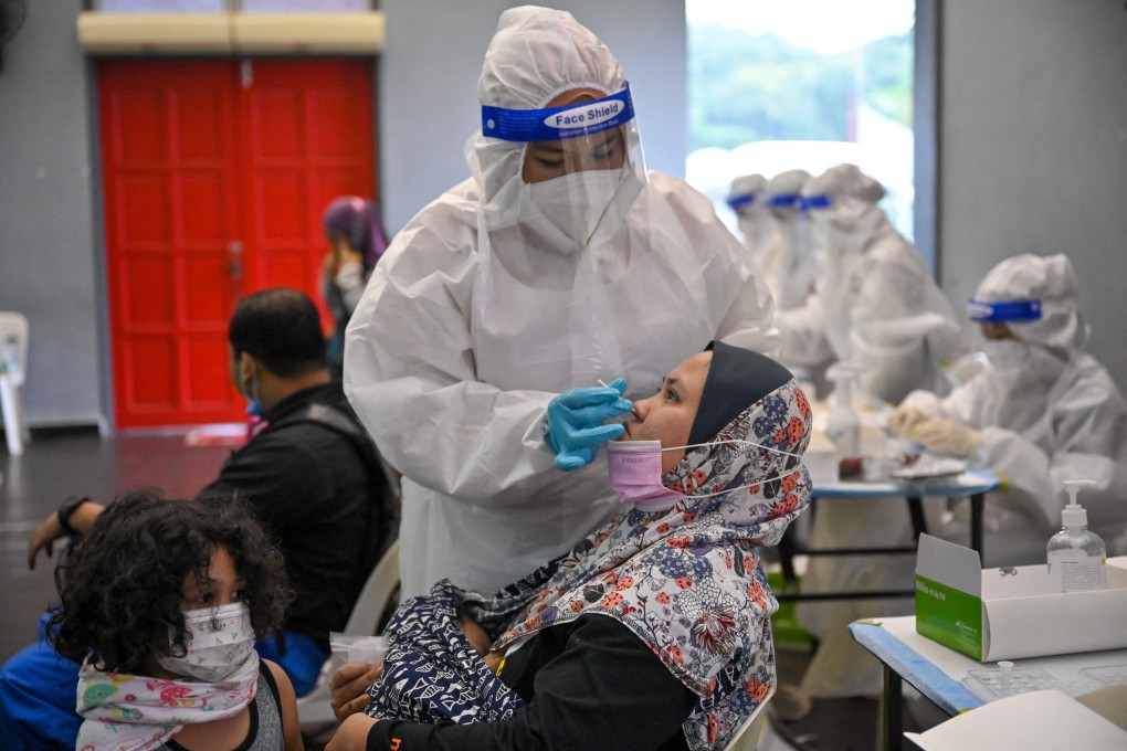 A medical worker conducts a Covid-19 test in Shah Alam, Malaysia. Photo: AFP