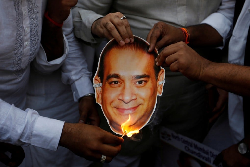 Activists burn a cut-out showing an image of billionaire Indian jeweller Nirav Modi – who alongside his uncle Mehul Choksi is wanted in India over the US$2 billion Punjab National Bank fraud – during a protest in Mumbai in 2018. Photo: Reuters