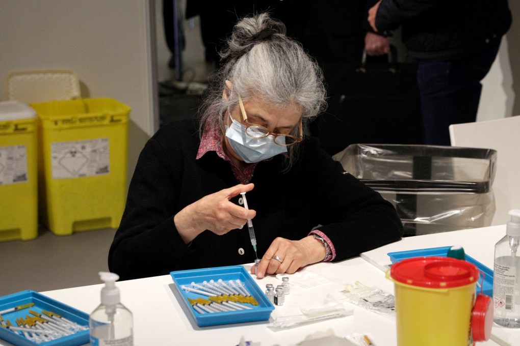 A nurse prepares doses of the Pfizer Covid-19 vaccine in Paris, France. Photo: AFP
