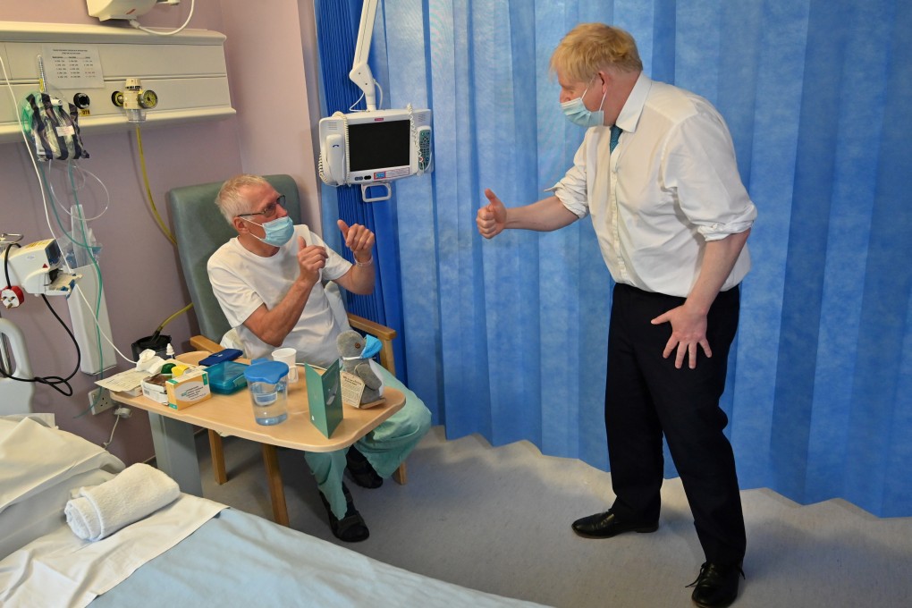 Britain's Prime Minister Boris Johnson interacts with a patient at a hospital in Colchester on Thursday. Photo: Reuters