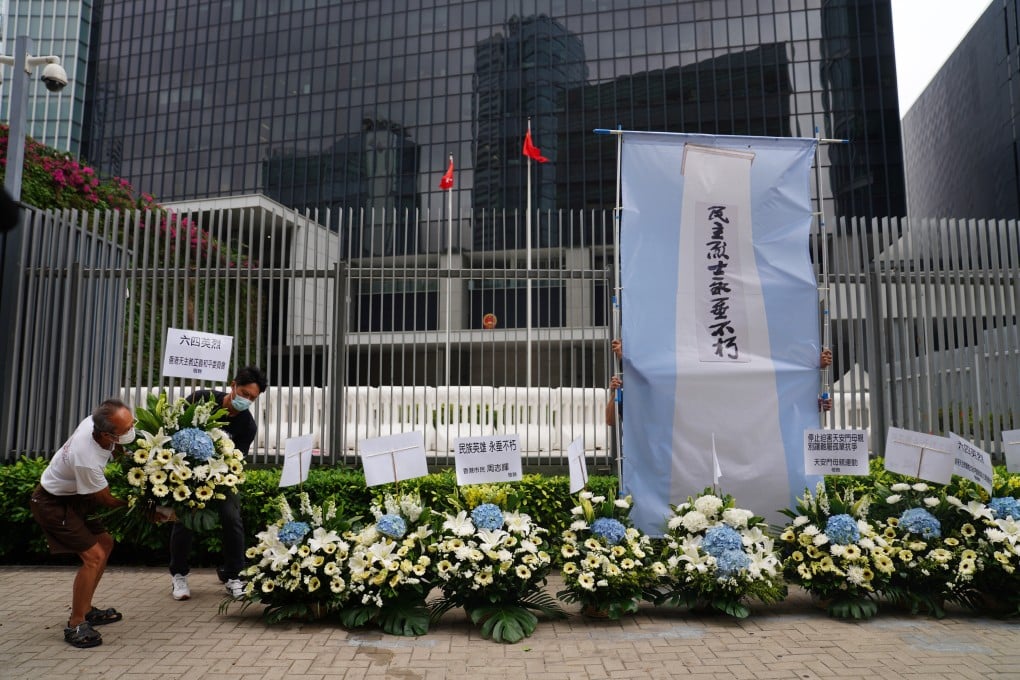 Members of the Hong Kong Alliance in Support of Patriotic Democratic Movements of China lay flowers for a memorial on June 4th outside the Central Government Offices (CGO) at Admiralty. Photo: SCMP / Sam Tsang