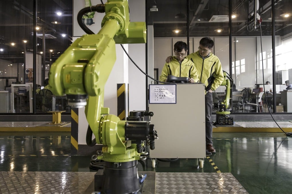 Technicians test robots in a E-Deodar Robot Equipment Co factory in Foshan, a part of the Greater Bay Area, on February 28, 2017. The Greater Bay Area is where the future of finance and technology is being written and start-ups in the Asean region can learn from its experiences. Photo: Bloomberg