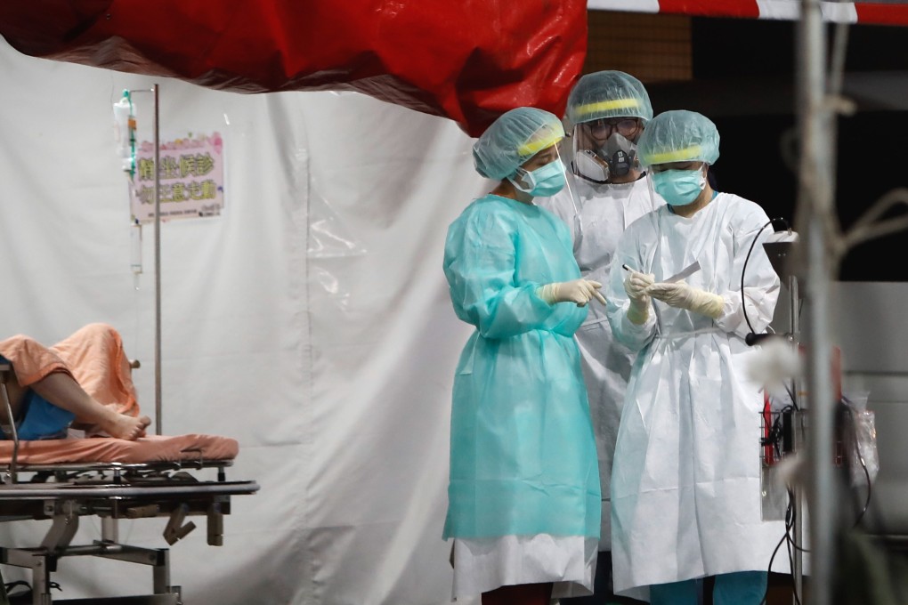 Medical workers consult at a temporary outdoor ward in Taipei. Photo: DPA