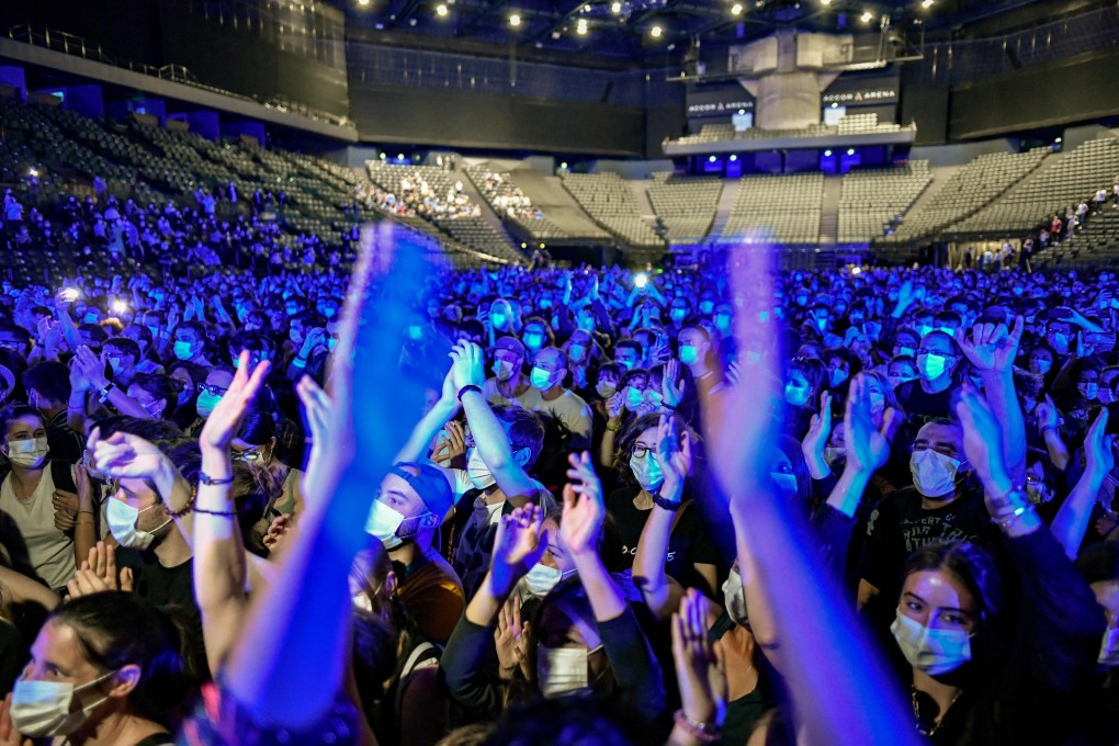 People cheer during a concert of French DJ Etienne de Crecy and pop band Indochine at the AccorHotels Arena in Paris on Saturday. Photo: AFP