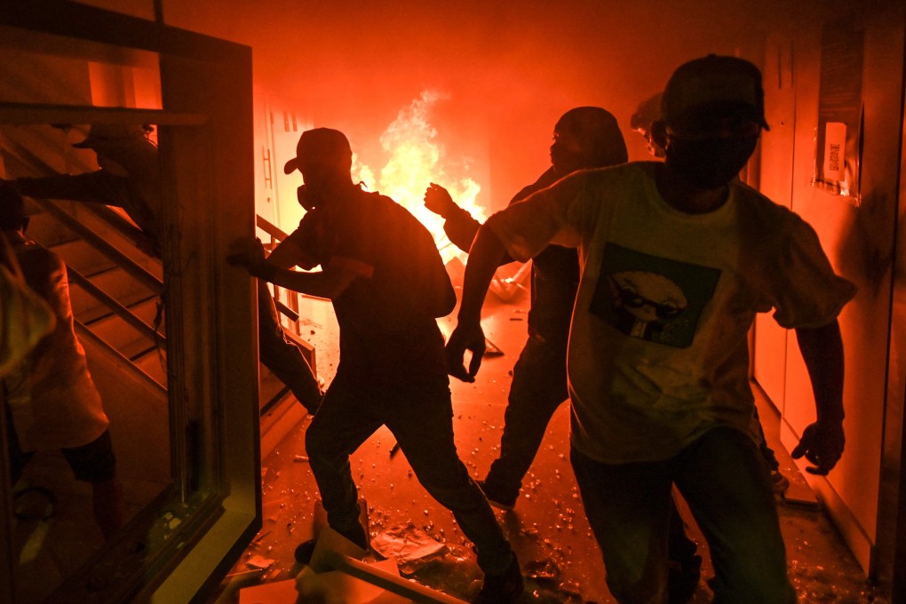 A bank office is burnt by demonstrators in Medellin, Colombia, on Friday. Photo: AFP