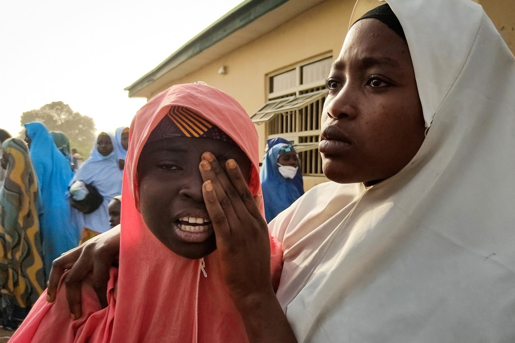 A kidnapped girl reunites with a family member in March after gunmen kidnapped students from a boarding school in northwestern Nigeria in February. File photo: AFP