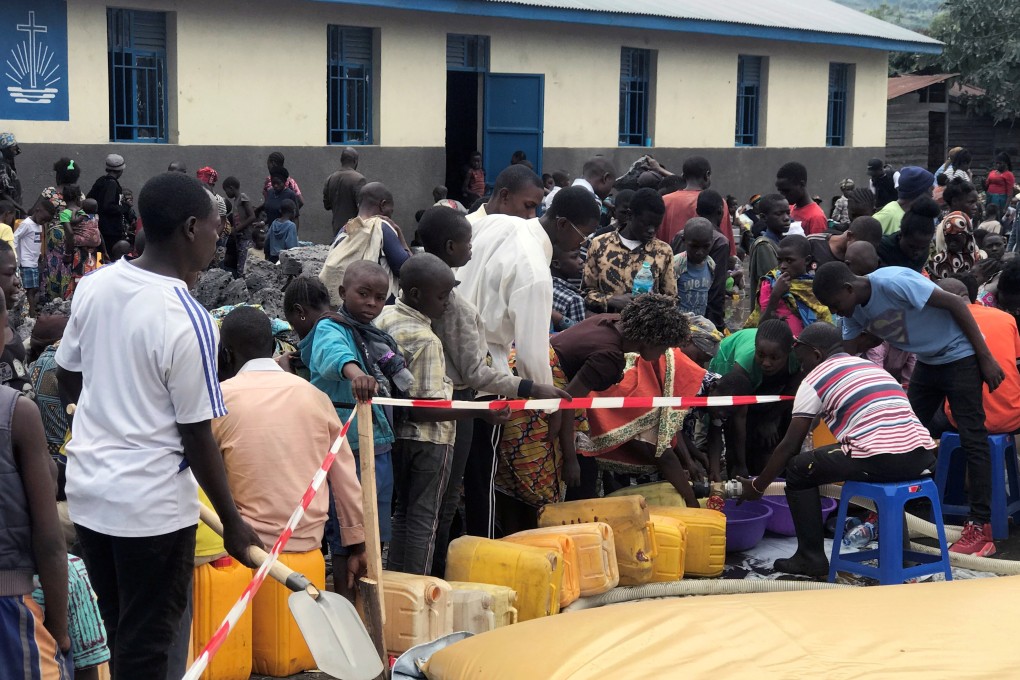 Internally displaced Congolese collect water outside a church in Sake town, near Goma, in Democratic Republic of Congo. Photo: Reuters