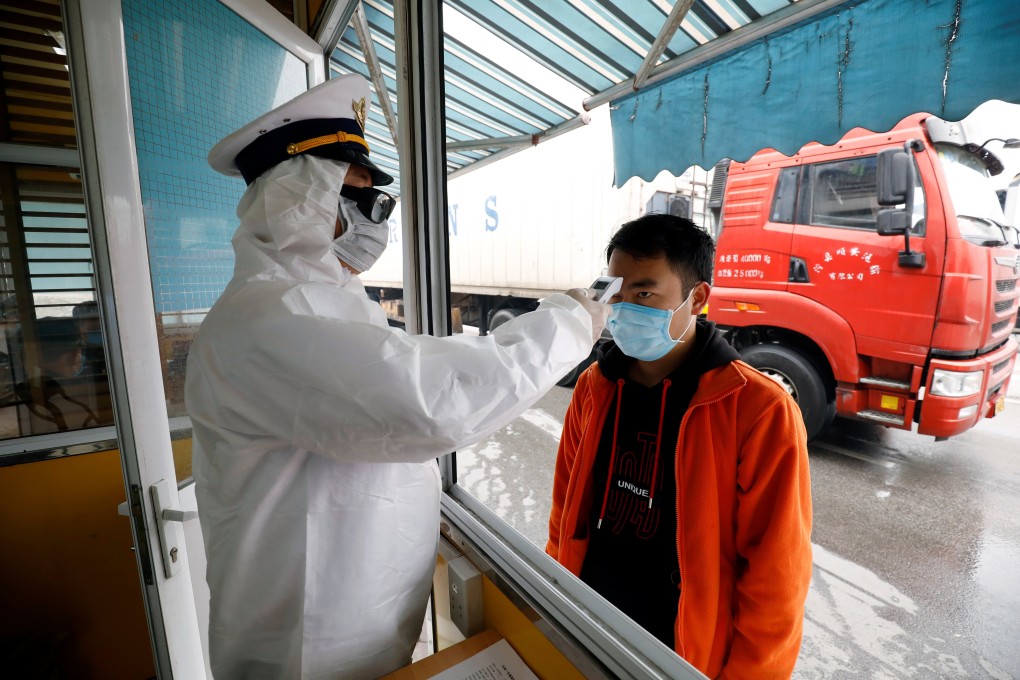 A Chinese truck driver gets a temperature check at the Huu Nghi border post in Lang Son, Vietnam. There are restrictions on foreign visitors on both sides of the border. Photo: Reuters