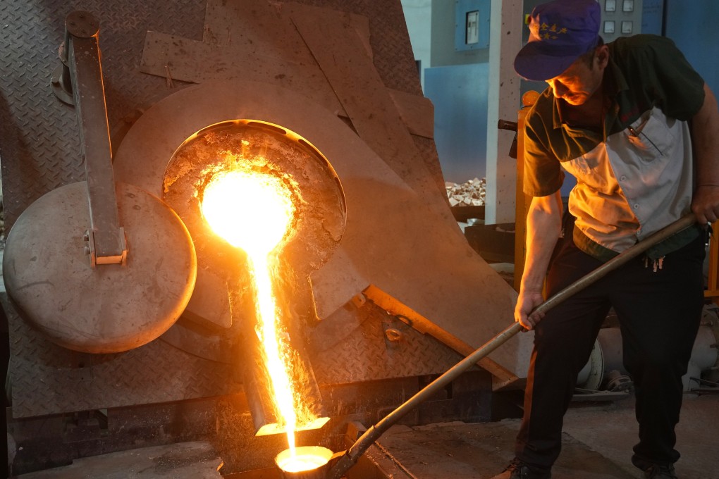 A worker gets copper solution for conducting pouring work at a factory in northern China's Hebei Province in May 2021. Photo: Xinhua