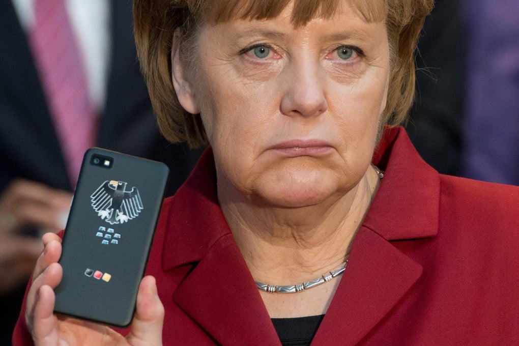 German Chancellor Angela Merkel with a tap-proof mobile phone at a computer expo in Hanover, Germany in 2013. File photo: EPA