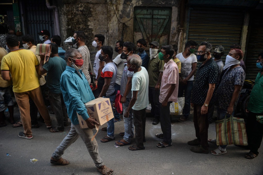 People queue to buy alcohol in Siliguri, West Bengal, India. Photo: AFP