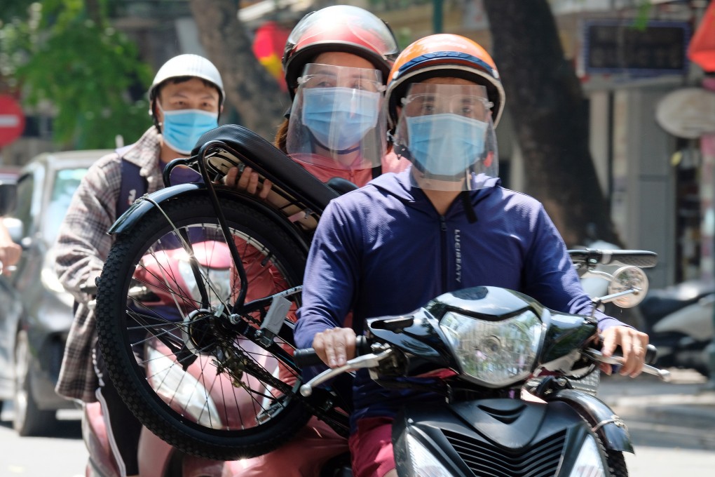 Motorists wear face masks in Hanoi, Vietnam, amid a fresh coronavirus outbreak. Photo: EPA-EFE