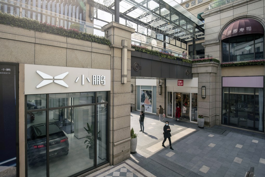 Shoppers walk past an XPeng showroom at Chamtime Plaza in Shanghai, China. Photo: Bloomberg