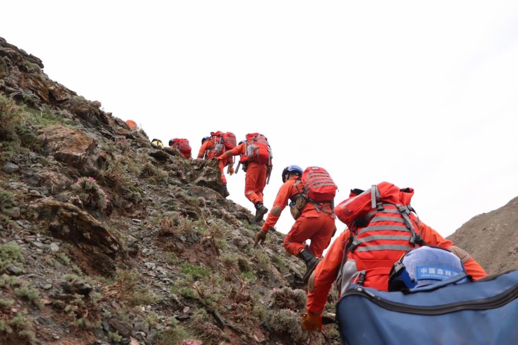 Rescue workers search for survivors on the mountainside. Photo: Xinhua