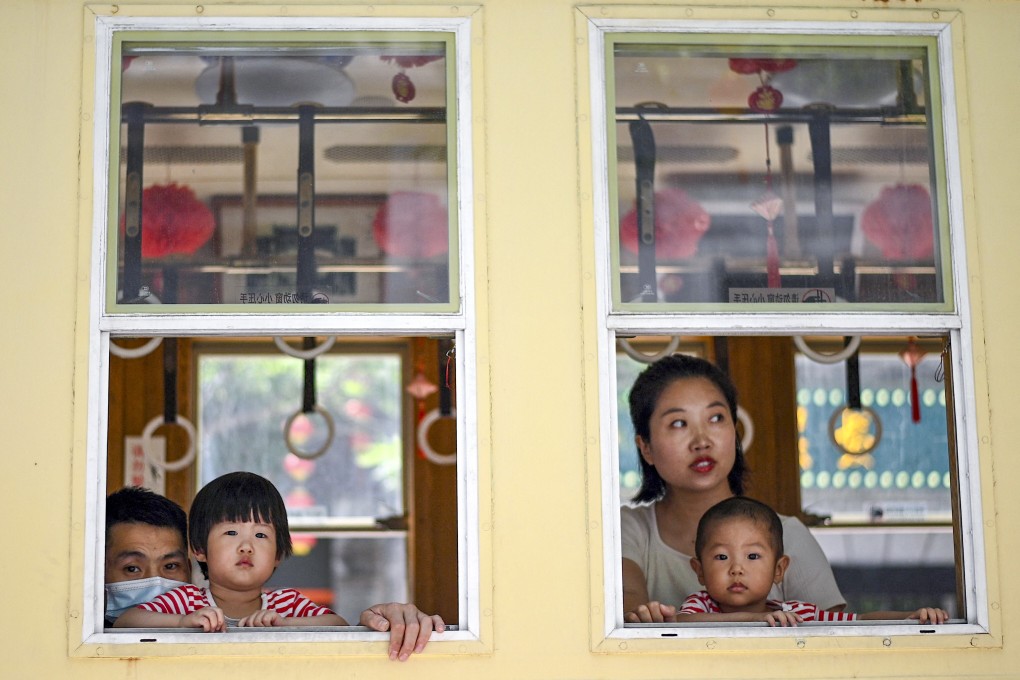 A family at Qianmen Street, a popular tourist and shopping area in Beijing. Housing incentives might not be enough and Beijing might have to roll out more aggressive policies to promote its new three-child policy, according to an analyst. Photo: AFP