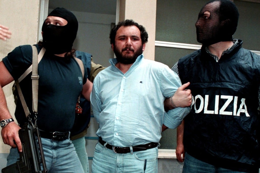 Giovani Brusca leaves Palermo's police headquarters to be taken to a maximum security prison. Photo: Reuters