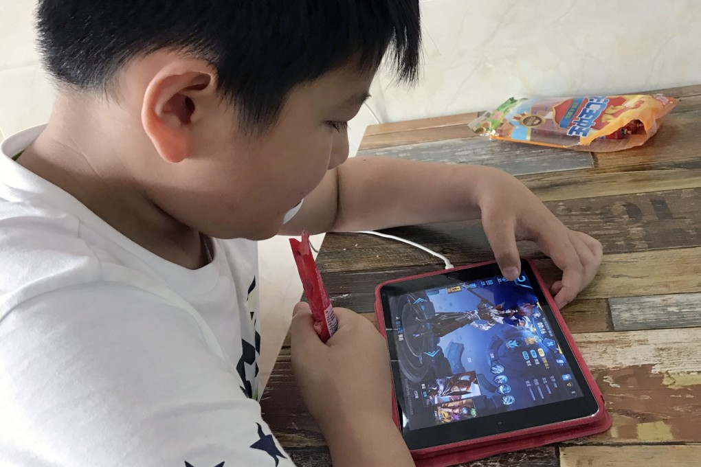 A boy is seen playing Tencent Holdings’ popular fantasy role-playing game Honour of Kings. Photo: SCMP