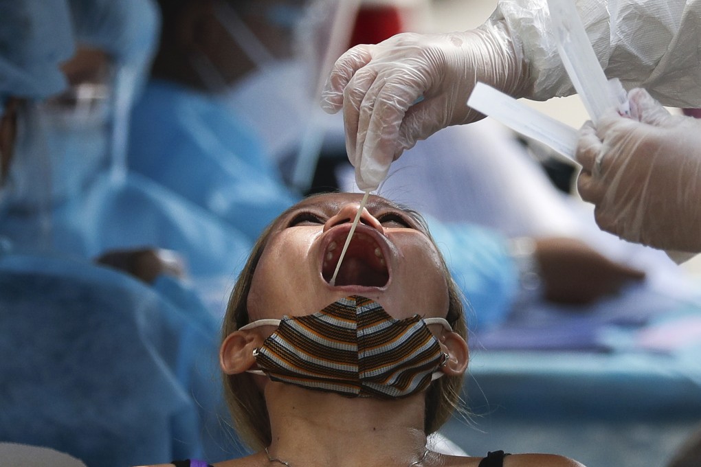 A health worker conducts a Covid-19 swab test on a resident in Quezon City in the Philippines on Monday. Photo: AP