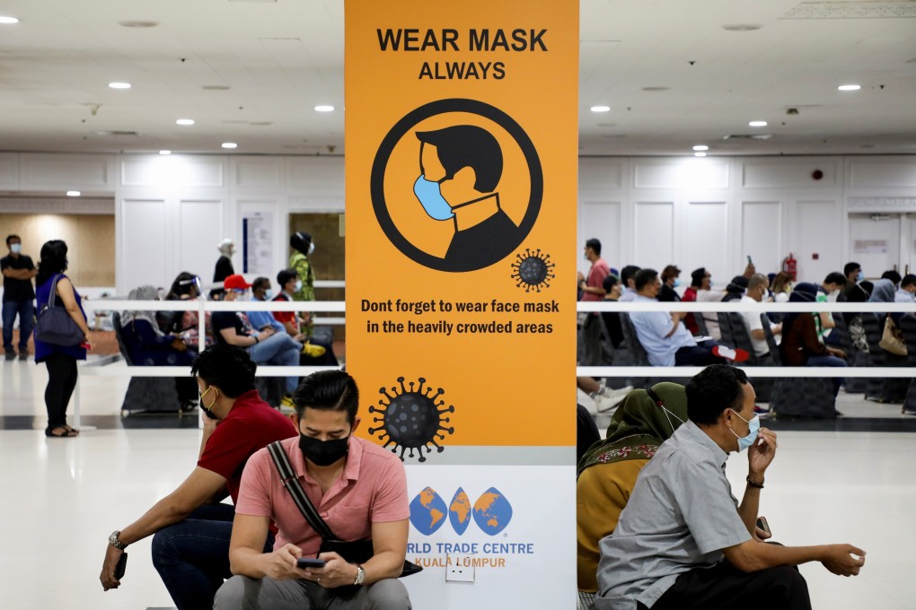 People wait to receive a Covid-19 vaccine at a vaccination centre in Kuala Lumpur, Malaysia. Photo: Reuters