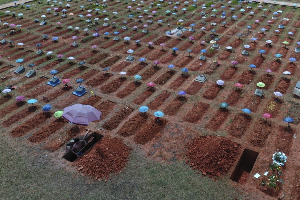 A worker digs a grave in the San Juan Bautista cemetery in Iquitos, Peru in March. Photo: AP