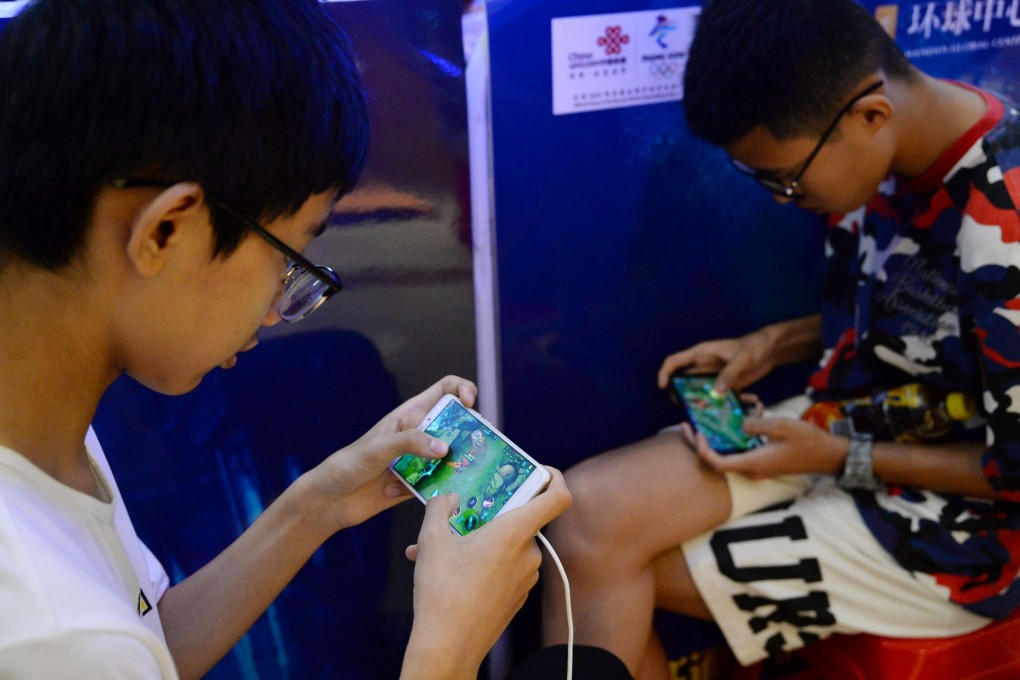 Young boys play the game Honour of Kings, developed by Tencent, during an event inside a shopping centre in Handan, Hebei province, on August 5, 2018. Photo: Reuters