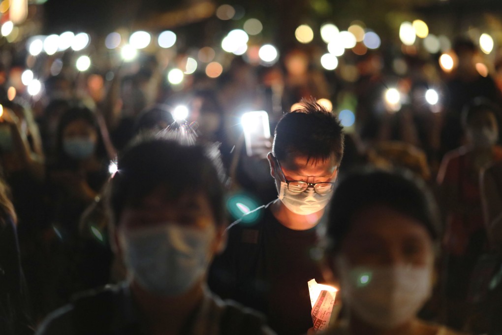 Residents light candles at the Kwun Tong waterfront during a candlelight vigil on June 4, 2020. Photo: K.Y. Cheng