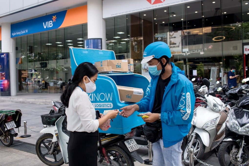 A customer pays after receiving an order from a Tiki.vn delivery rider in Vietnam’s Ho Chi Minh City. Photo: Bloomberg