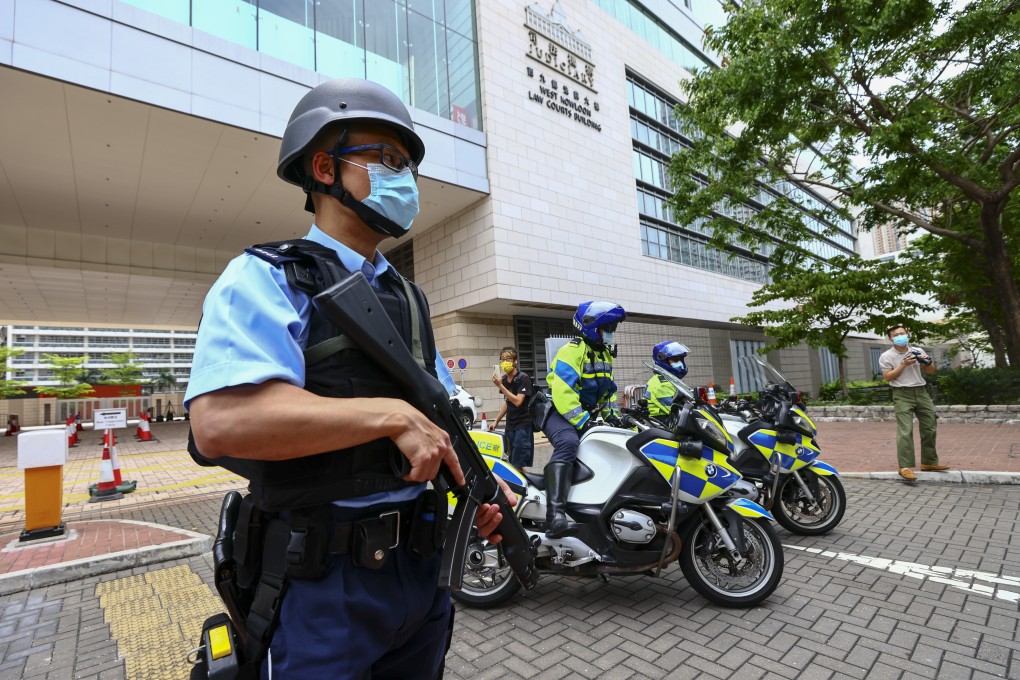 Police officers stand guard outside West Kowloon Magistrates’ Courts on March 7 before the arrival of an activist charged under the national security law. Photo: Dickson Lee