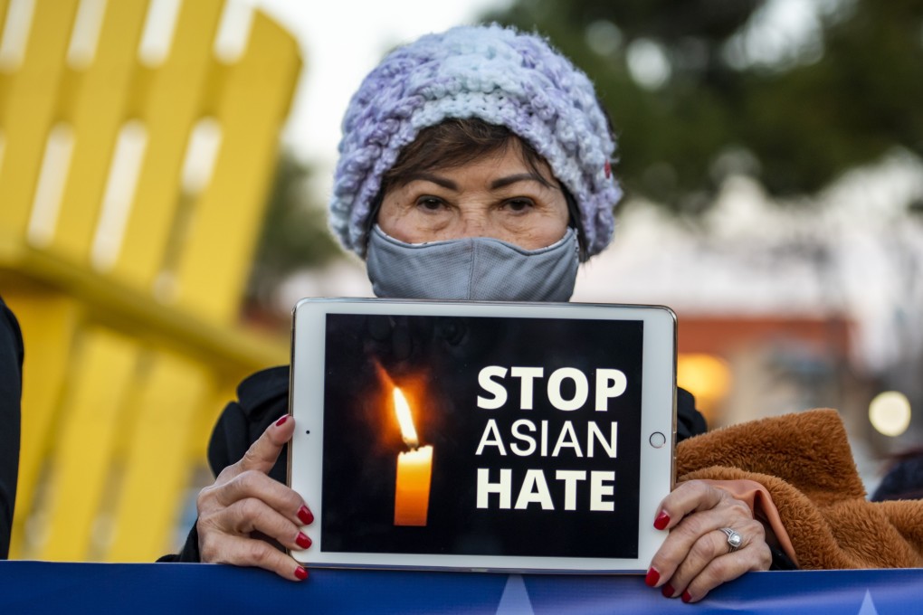 A woman holds up an iPad with the message “Stop Asian Hate” during a vigil in California in honour of victims of the Atlanta-area spa shootings in March. Photo: DPA