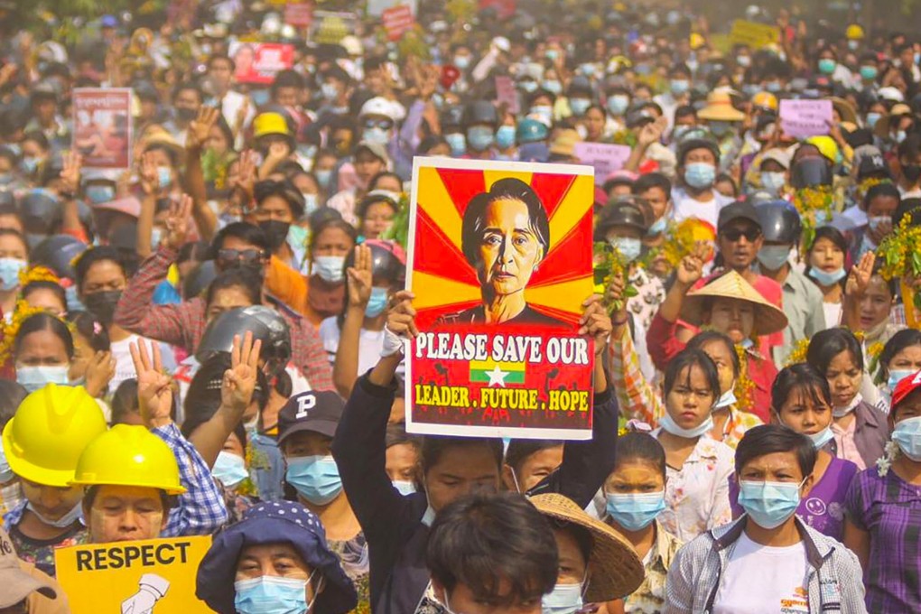 A protester holds a poster featuring Myanmar’s detained civilian leader Aung San Suu Kyi during a demonstration against the military coup in April. Photo: Handout/Facebook via AFP