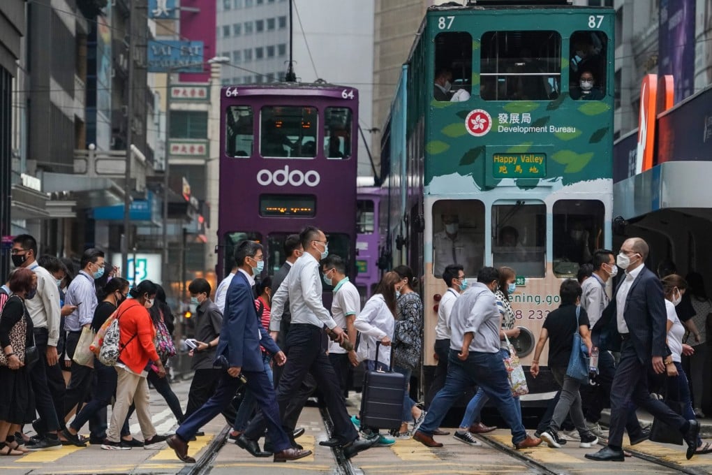 Office workers crossing a busy street in Hong Kong’s financial district in Central. Photo: Felix Wong