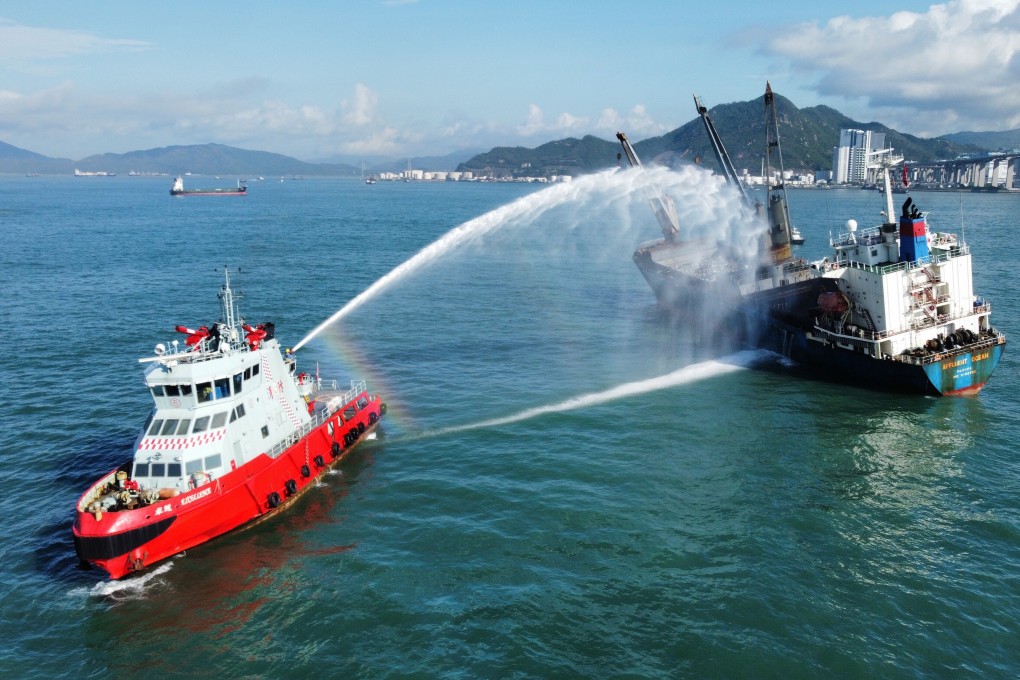 A rescue boat uses water cannon to douse the last of the flames on the stricken vessel. Photo: Martin Chan