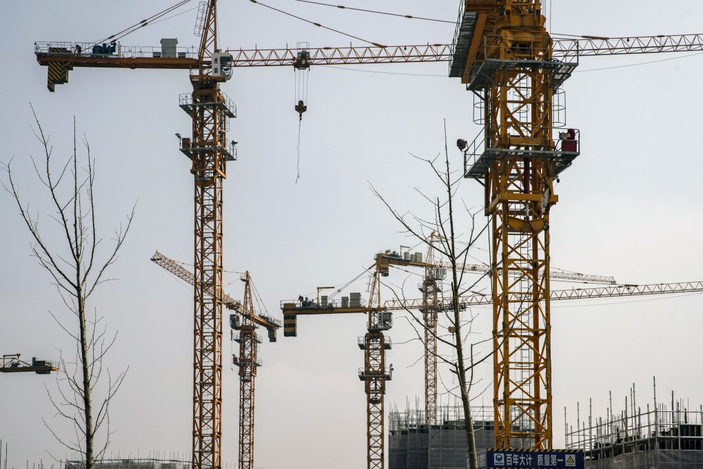 Cranes are seen at a construction site for a residential development on the outskirts of Shanghai on March 14. More land is being made available in the hope of curbing price rises. Photo: Bloomberg