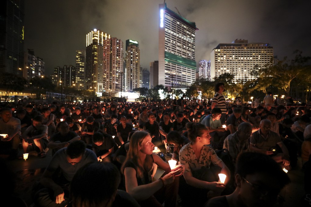 Crowds hold up their candles at the 2019 June 4th Candle Light Vigil, marking the 30th anniversary of the Tiananmen Square crackdown in 1989, in Victoria Park. Photo: James Wendlinger