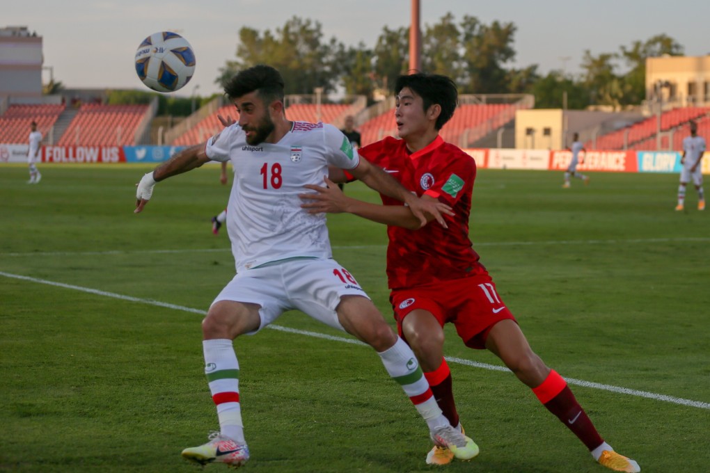 Hong Kong’s Shinichi Chan and Iran’s Ali Gholi Zadeh tussle for the ball in the 2022 World Cup qualifiers in Bahrain. Hong Kong lost 3-1. Photo: HKFA