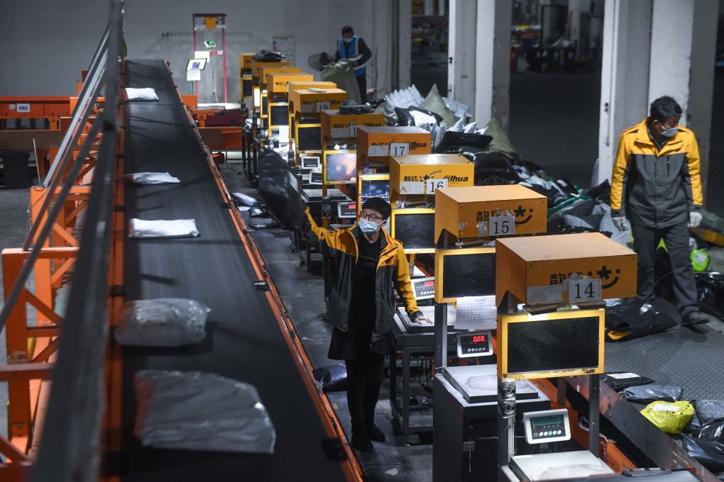 Workers handle packages for delivery at a warehouse in Huzhou, Zhejiang Province, Feb. 8, 2021. The country’s two biggest shopping sprees serve as a barometer of consumer sentiment in the world’s second-largest economy. Photo: Xinhua