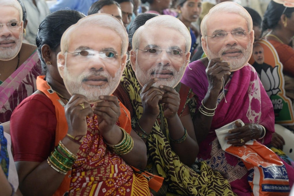 BJP supporters wear a mask of PM Narendra Modi at a rally in Hyderabad. File photo: AFP
