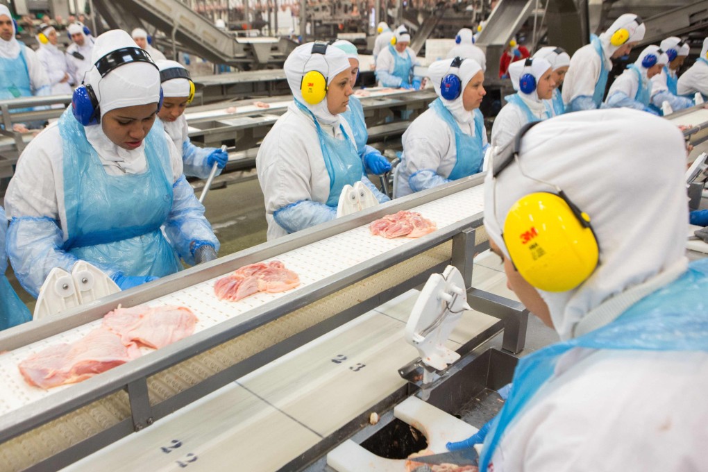 People work at a production line of the JBS-Friboi chicken processing plant during an inspection visit on March 21, 2017. The American subsidiary of the world's largest meat processing company said on May 31, 2021, that it had been hacked. Photo: AFP