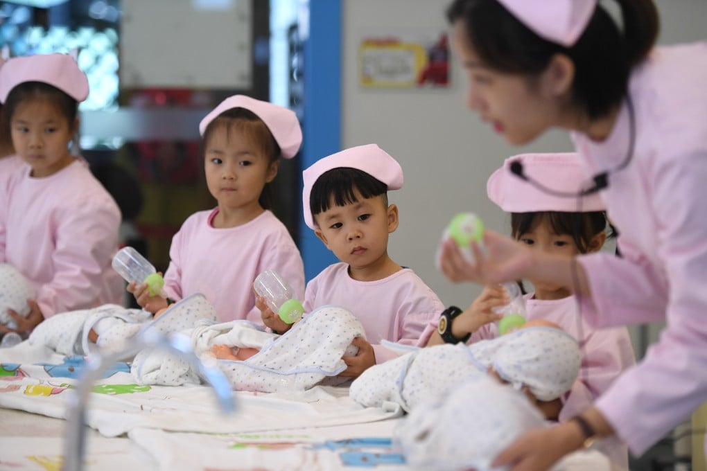 Children learn how to care for infants in Hangzhou, the capital of east China’s Zhejiang province, in October 2017. The latest population census found that Chinese mothers gave birth to 12 million babies last year, down from 14.65 million in 2019. Photo: Xinhua