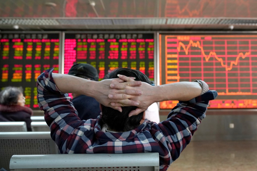 An investor looks at a stock quotation board at a brokerage office in Beijing, China January 3, 2020. Photo: Reuters