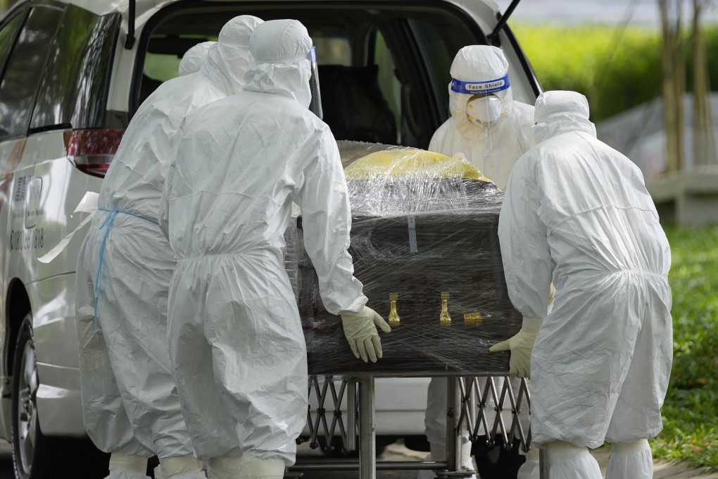 Health workers wearing protective gear carry a coffin during a funeral for a Covid-19 victim in Semenyih, Malaysia, last month. Photo: AP