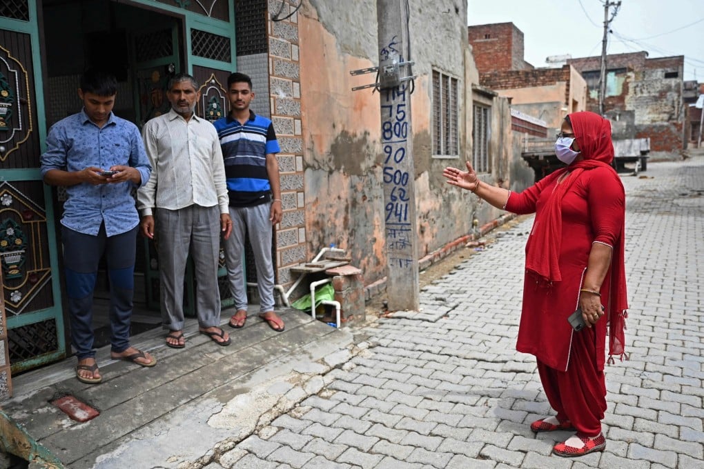 An Indian health worker seeking to raise awareness about Covid-19 goes door-to-door in Kalwa village on the outskirts of Jind. Photo: AFP