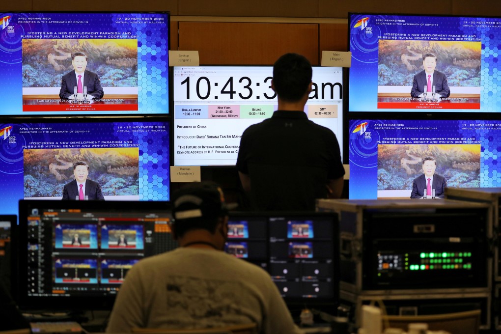 People in Kuala Lumpur, Malaysia look at a screen showing China's President Xi Jinping speaking during the virtual Apec CEO Dialogues 2020 last year. Photo: Reuters