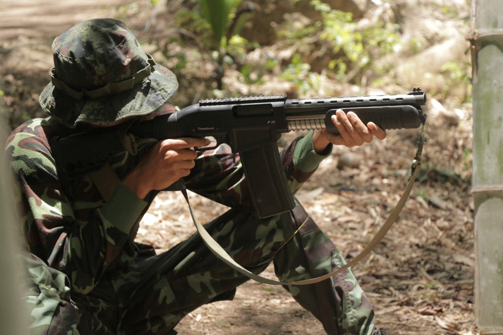 An anti-coup activist aims a weapon while undergoing military training at a camp in Myanmar’s Karen state. Photo: AFP