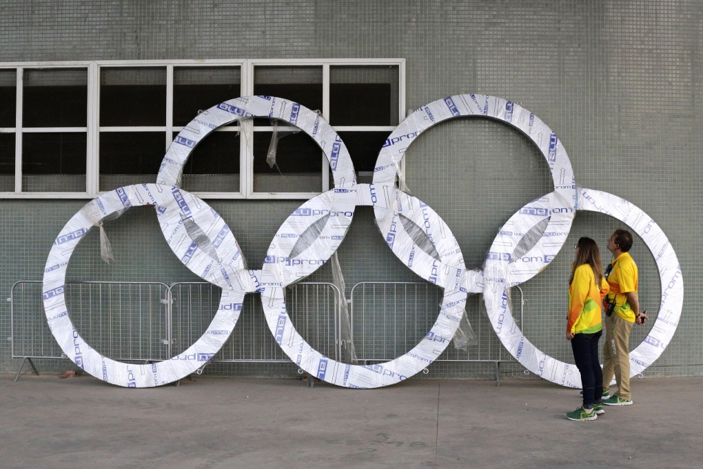 Workers inspect a set of Olympic Rings that are scheduled to be installed inside Olympic Park in Rio de Janeiro, Brazil, in 2016. Photo: AP
