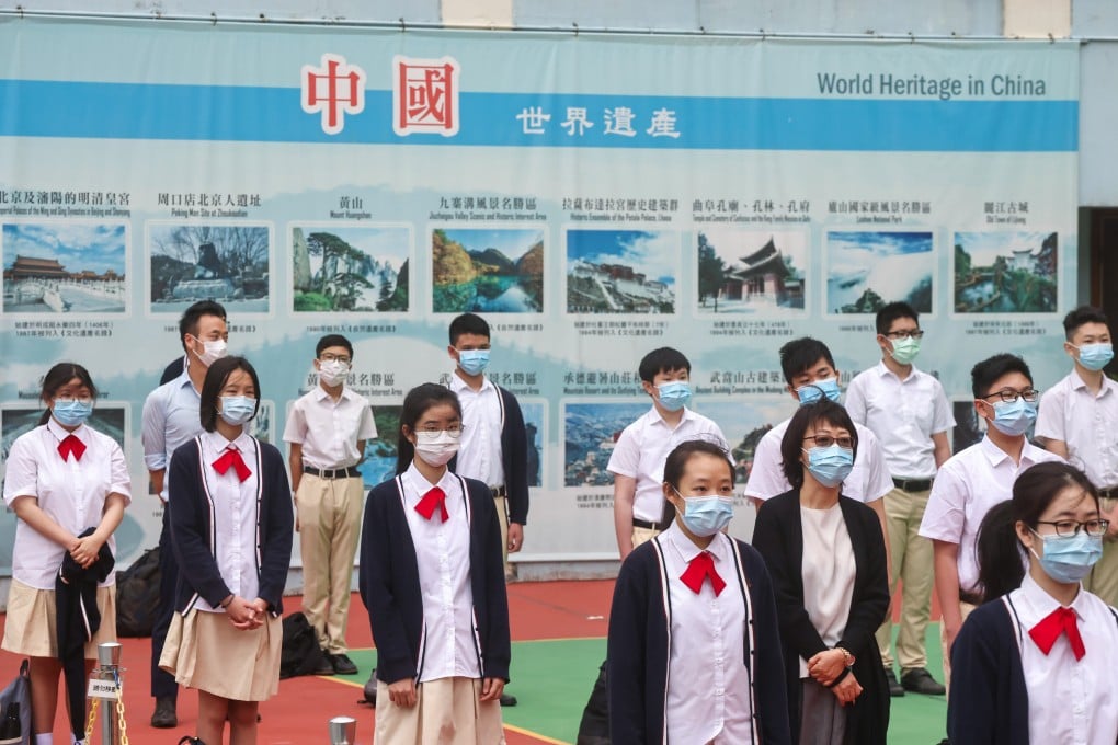 Pupils watch the Chinese national flag being raised at Gertrude Simon Lutheran College, in Yuen Long, during National Security Education Day on April 15. Photo: K.Y. Cheng