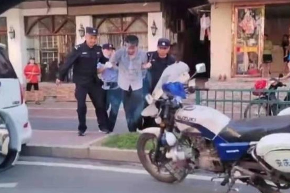 The suspected killer is led away by police. Photo: Weibo