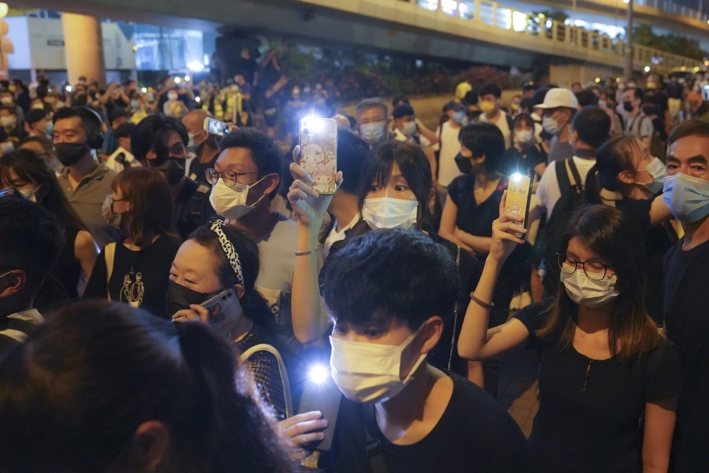 Hongkongers turn on the lights of their mobile phones as a way of marking June 4 after police banned the traditional vigil. Photo: Sam Tsang