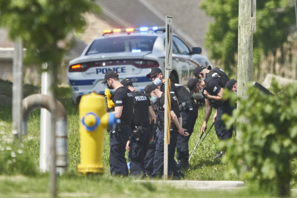 Police investigate at the scene of a car crash in London, Ontario, on Monday. Photo: The Canadian Press via AP